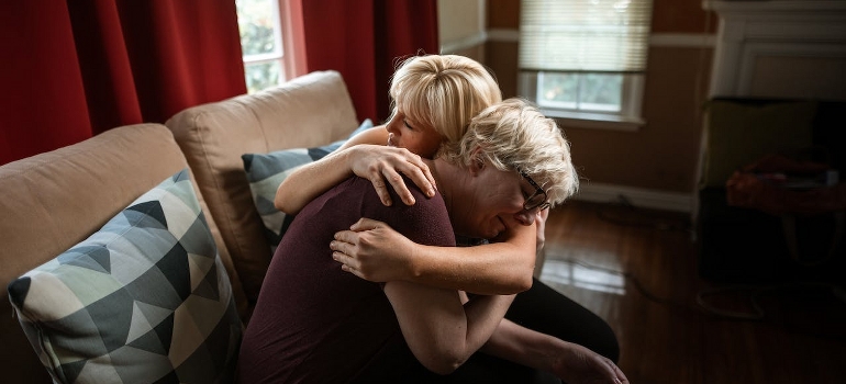 Two women are hugging after family-centered recovery at Little Creek. 