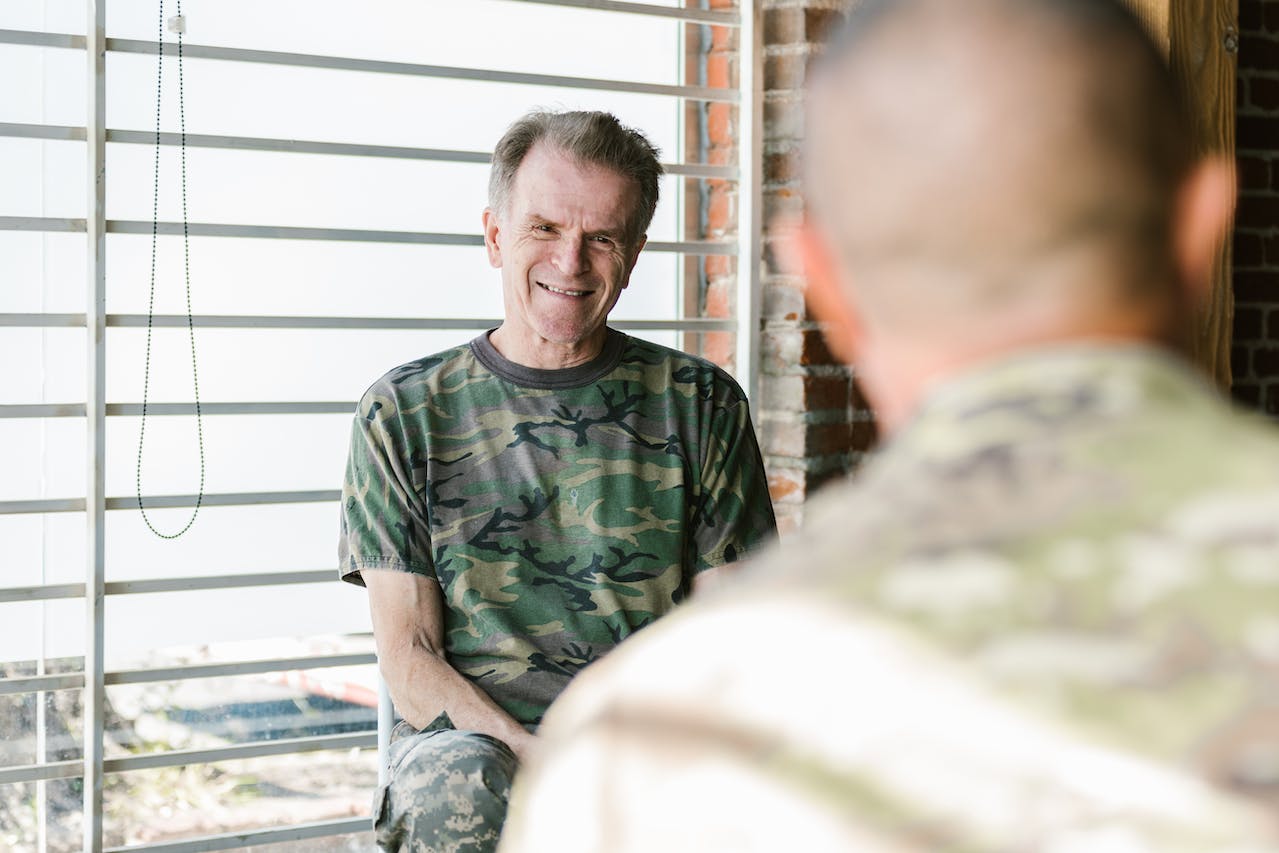 The veteran is sitting beside the window and thinking about veterans' substance abuse stats for NJ and NY.