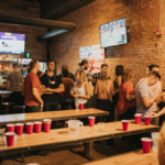 Pennsylvania college students in a bar playing beer pong