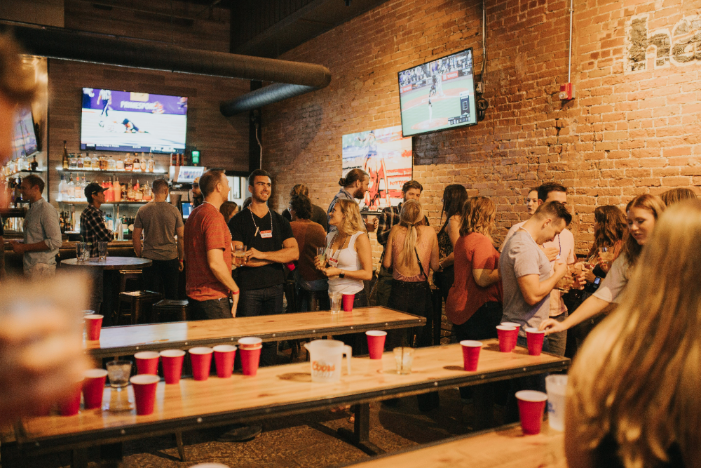 Pennsylvania college students in a bar playing beer pong