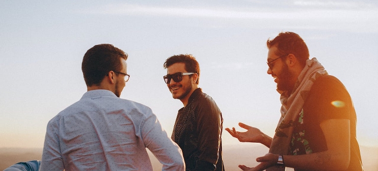 Three men talking and laughing.