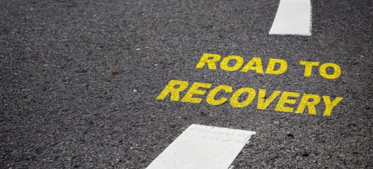 A route with "road to recovery" painted in yellow on it