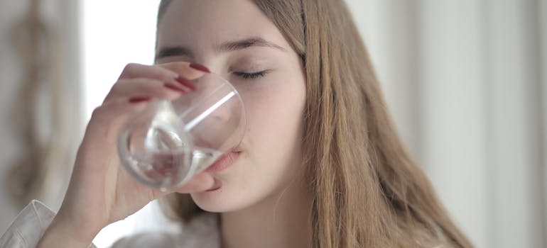woman drinking water and wondering how long do opioids stay in your system
