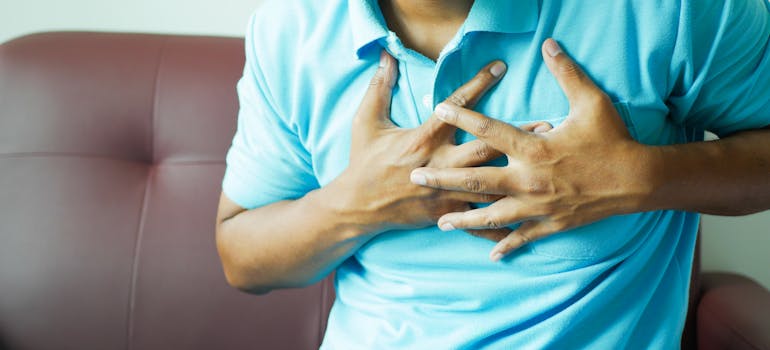 Man experiencing irregular heartbeat, one of the main Methadone side effects.