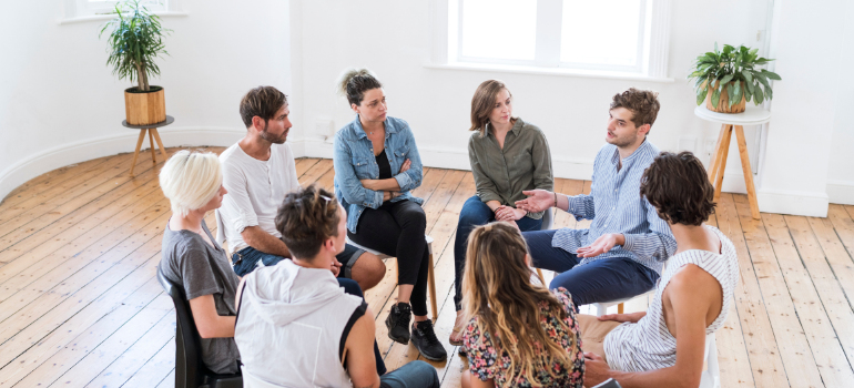 young men and women participating in group therapy