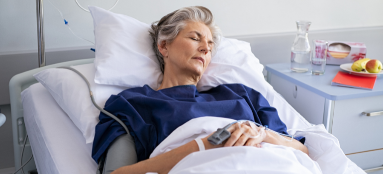An older woman is in a hospital bed because of Tramadol side effects.