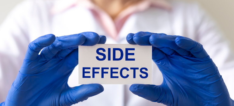 A medical professional holding a paper that says side effects