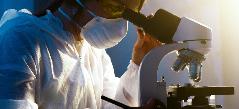 A person using a microscope wondering if Urine Test Differentiate Between Different Benzodiazepines