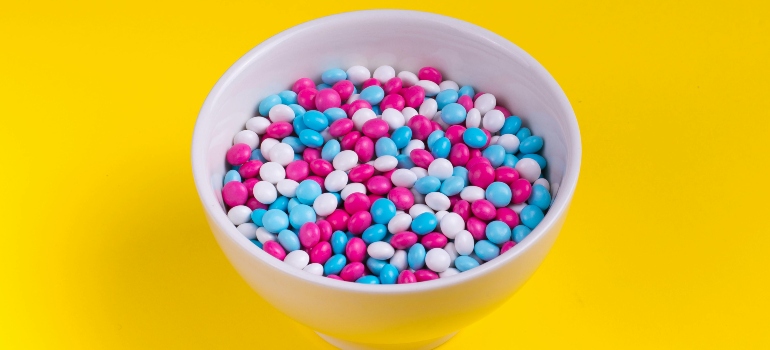 Pink and blue candies in a bowl