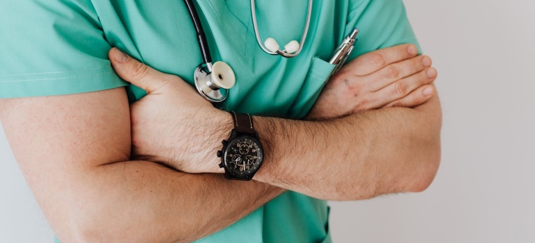 a doctor with arms crossed thinking about the link between Adderall and kidney failure