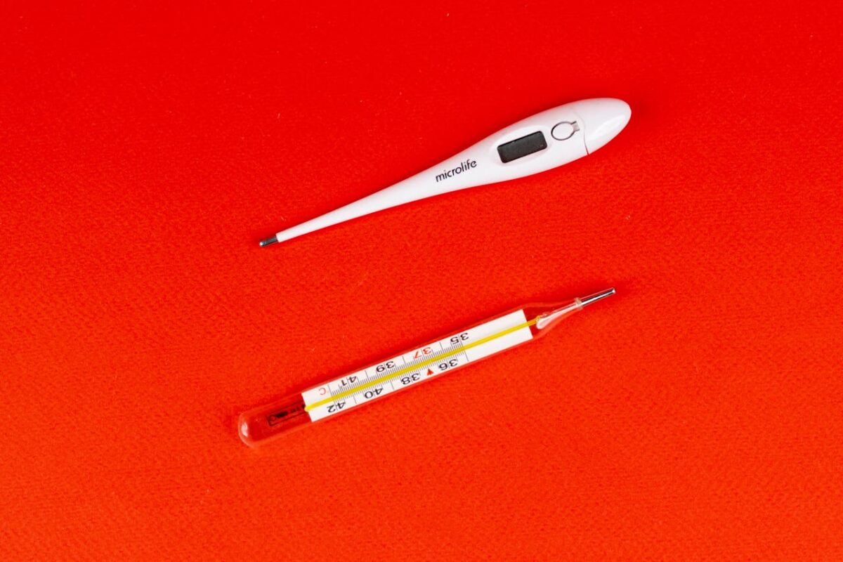 Two different thermometers in a red surface