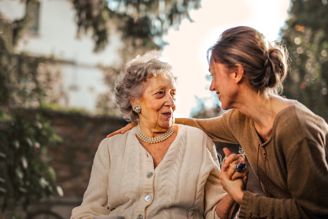 Mother and daughter talking in a garden