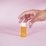 a person reaching for a bottle of pills wondering does valium show up on a drug test
