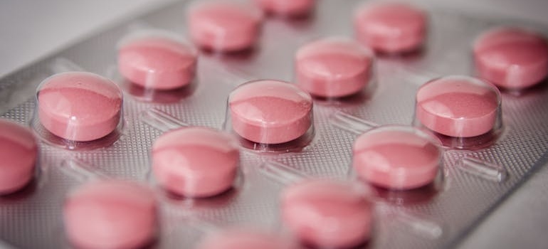 Red tablets in a blister representing benzos, some of the most damaging drugs for your brain.