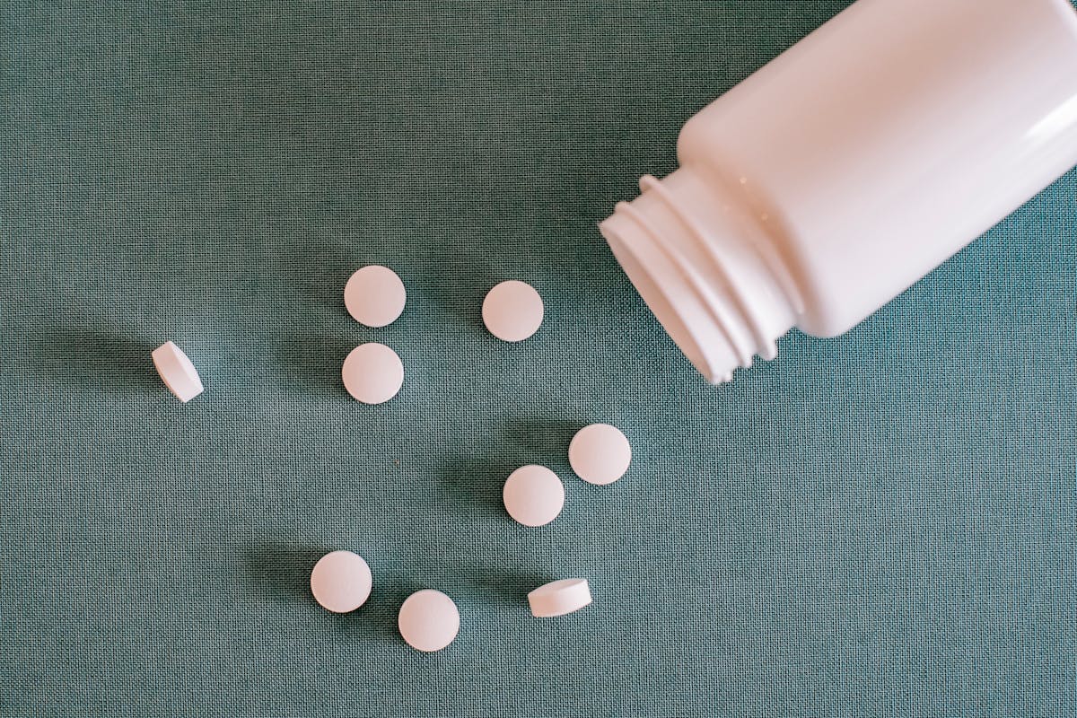 Pile of white pills with container