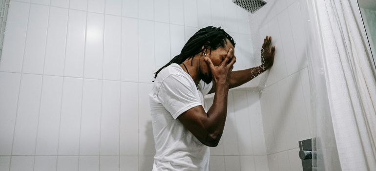 A stressed man in the shower