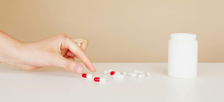 a person putting prescription medication on the table which are commonly abused substances among seniors in PA