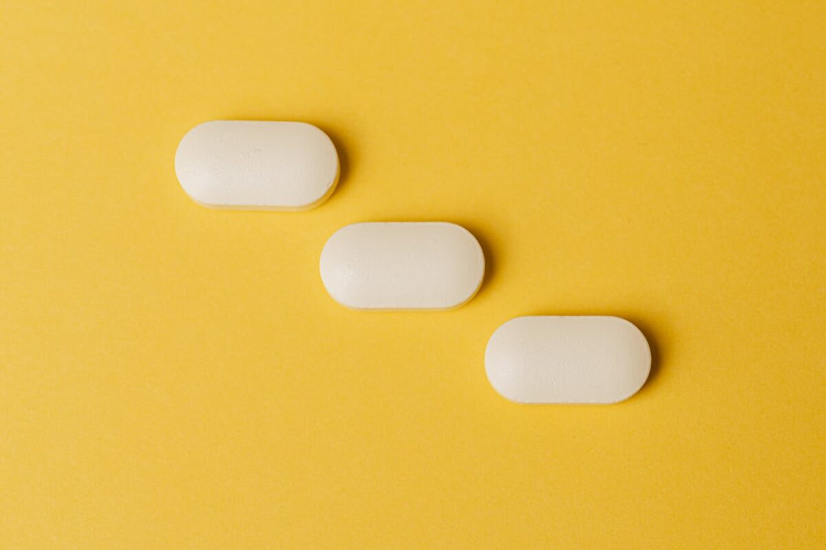 White pills on a yellow background