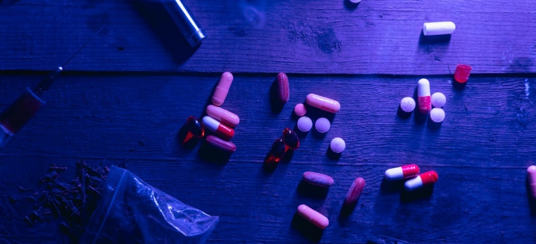 multiple drugs on a wooden table 
