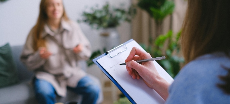 Therapist taking notes during a session