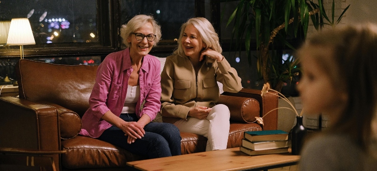 Two elderly women sitting on a sofa talking about the commonly abused substances among seniors in PA