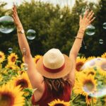a girl in a sunflower field enjoying Summer Social Activities in PA Without Alcohol