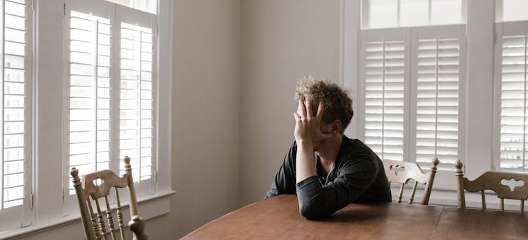 Man sitting at the table and going through the early Gabapentin withdrawal phase.