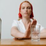 Woman refusing a drink.