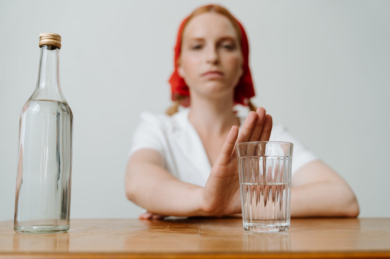 Woman refusing a drink.