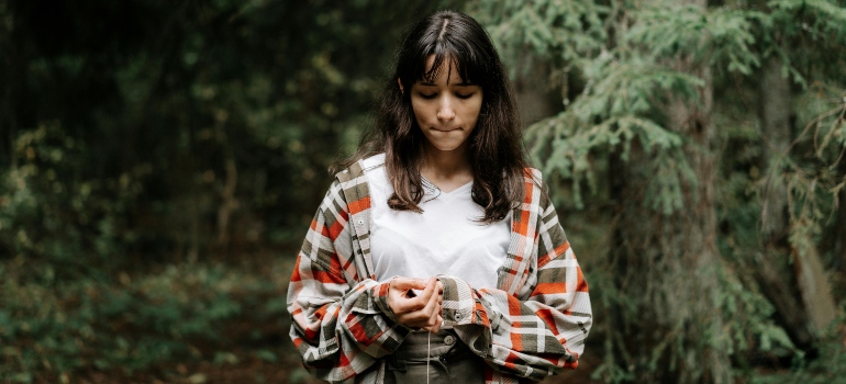 A teen girl standing outside