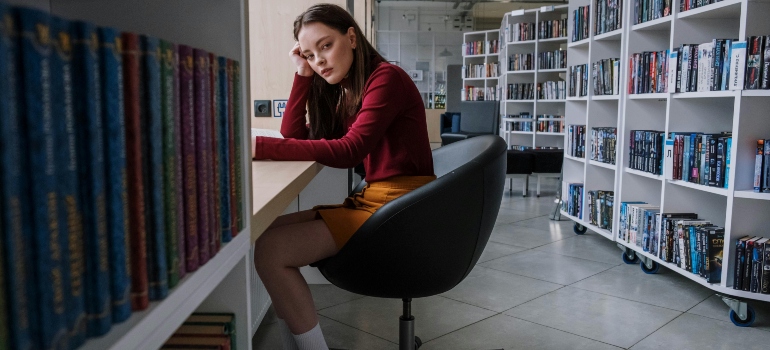 A teen girl sitting in a library