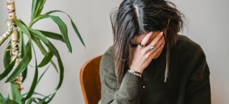 Woman sitting on a chair and crying while going through Gabapentin withdrawal.