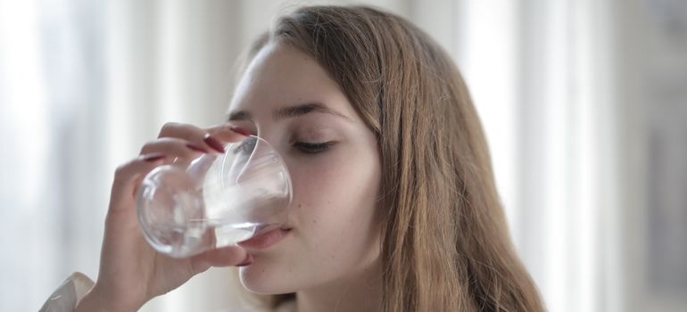 Woman drinking a glass of water.