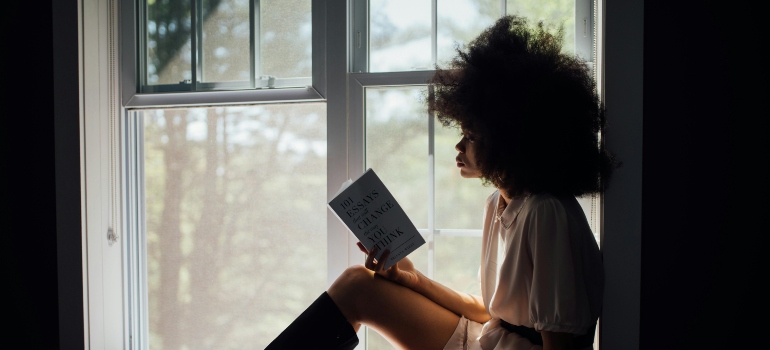 Woman reading a book about things to do in Pennsylvania in summer after getting sober