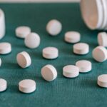 white pills on a green surface