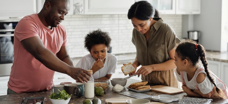 a family of four making a meal 