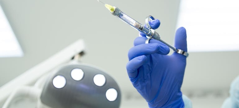 Nurse holding a syringe.