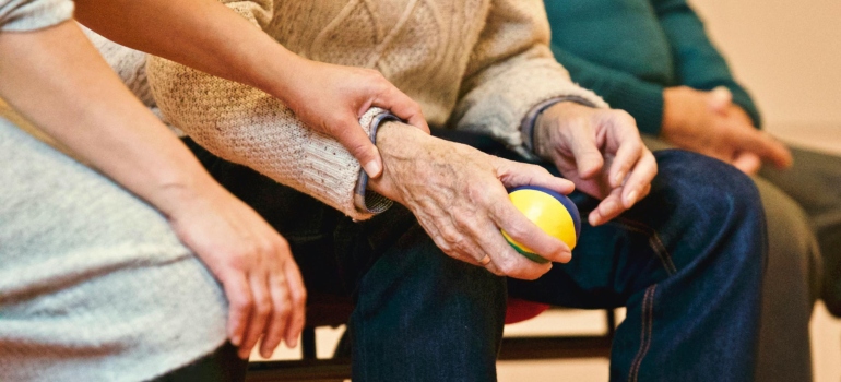 Man holding a stress ball and wondering are Shaky Hands A Sign of Alcoholism