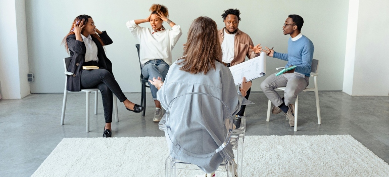 Four people in group therapy for post-acute withdrawal syndrome