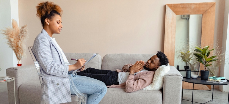 Man talking to a therapist while laying on a couch