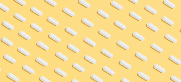 White pills on a yellow background