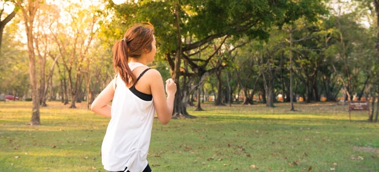 Woman running in the park thinking about the benefits of quitting weed