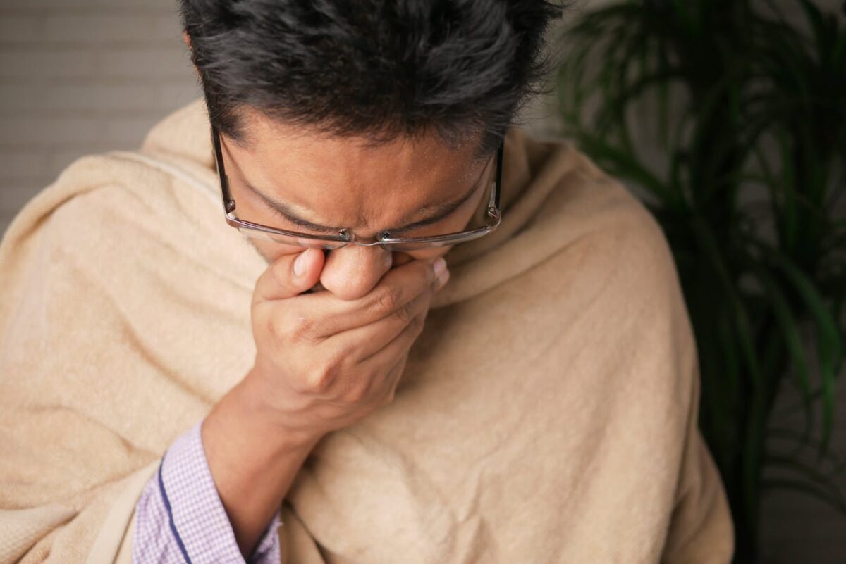 a man covering his nose