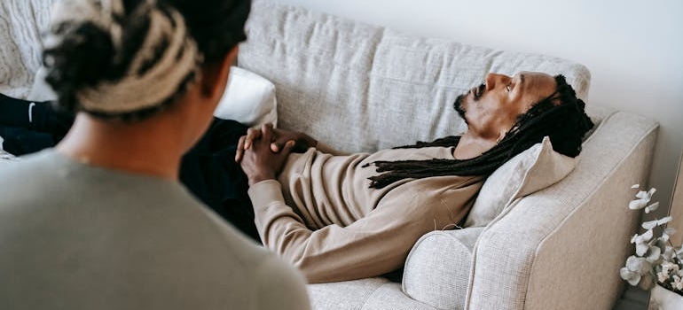 Man lying on a couch and talking to his therapist about Amphetamine vs. Methamphetamine.