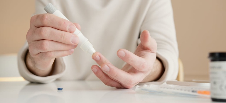 a woman checking her blood sugar 