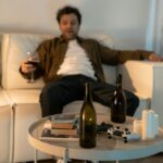 a drunk man sitting on the couch showing Alcohol Abuse and Family Dynamics
