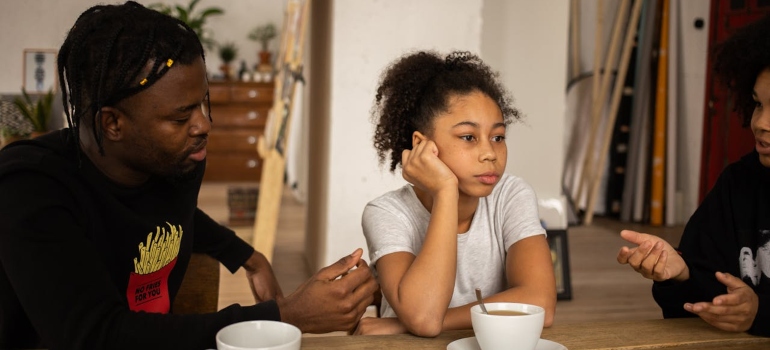 parents talking to a depressed child 