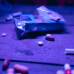 Pills next to an empty box of cigarettes as a symbol of speedball drug and other drugs