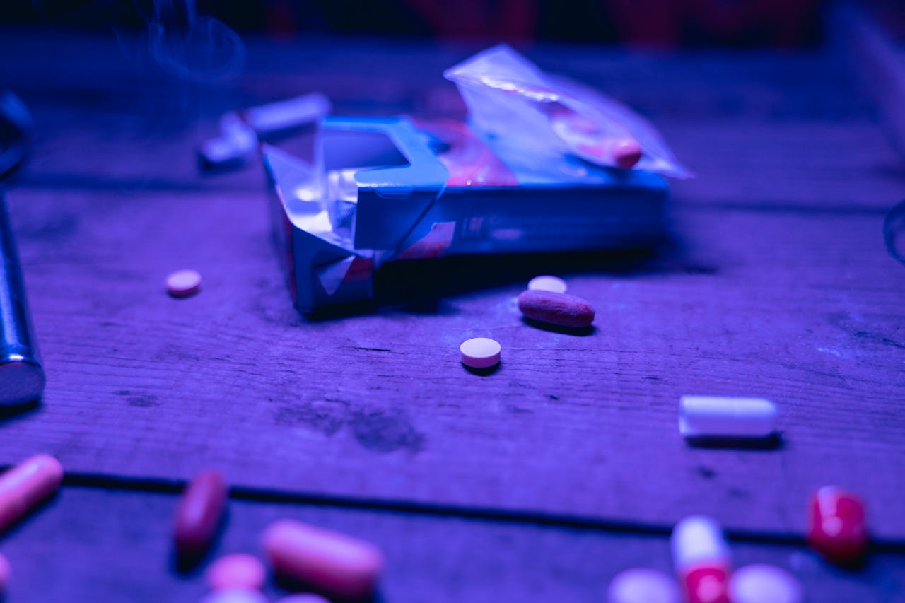 Pills next to an empty box of cigarettes as a symbol of speedball drug and other drugs