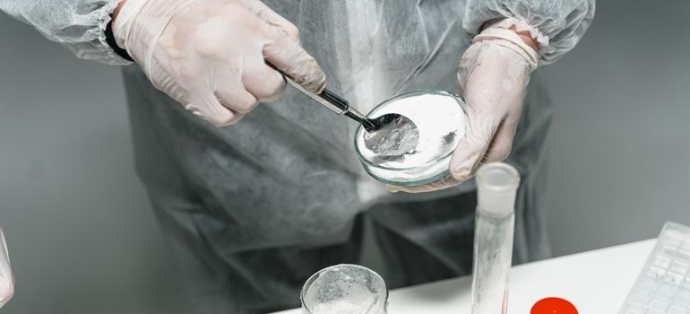 Scientist testing drug samples for pink cocaine in a laboratory.